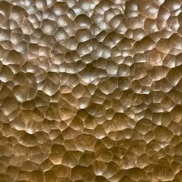 Gold hammered stainless steel sheet with large irregular pattern