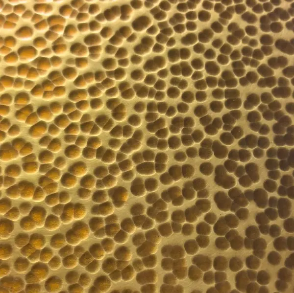 Gold hammered stainless steel sheet with dense decorative texture