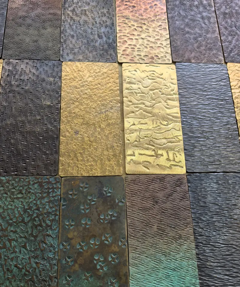 Hammered stainless steel samples showing different patterns, surface finishes and PVD colors
