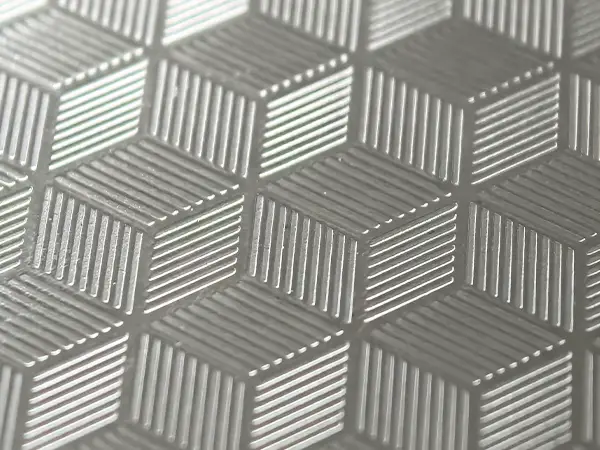 Embossed stainless steel sheet with textured surface